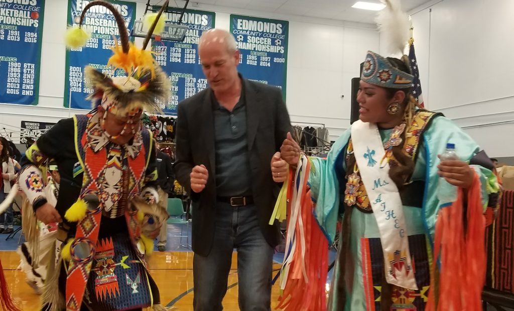 Congressman Rick Lasen pictured with two dancers.