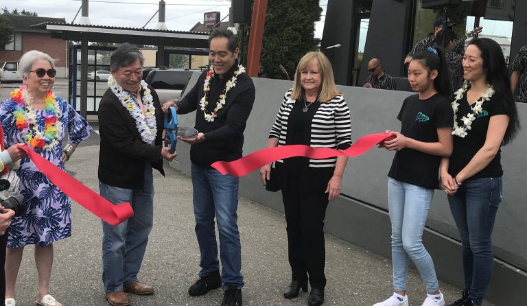 Lynnwood Times photo by Luke Putvin. Yuji Okumoto, Bob Hasegawa and others at Kona Kitchen ribbon cutting on June 22.