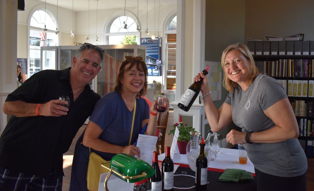 Lynnwood Times photo by Luke Putvin. Bill, Jeanne and representative from Three of Cups winery at the Edmonds Wine Walk.